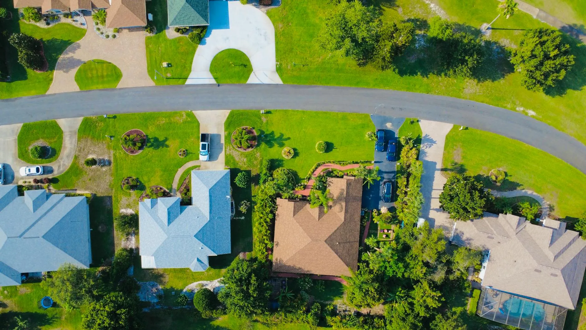 Aerial view of a Florida suburban neighborhood with green lawns and tile-roof homes