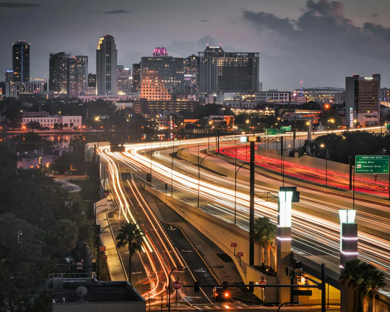 Aerial view of the Orlando, Florida skyline at dusk with light trails on highways