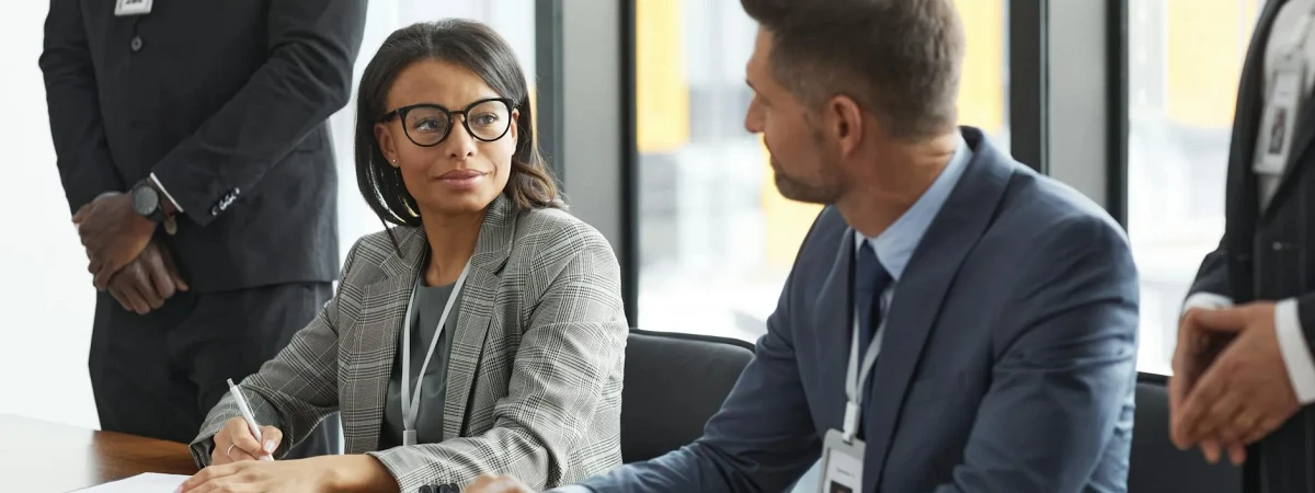 Business immigration attorney reviewing H-1B and L-1 petition documents with an Orlando employer — Florida Board Certified Immigration Law Center